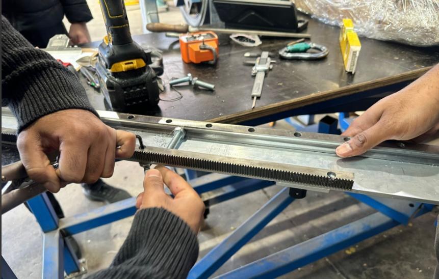 Hands fitting a steel rack to an aluminium support beam